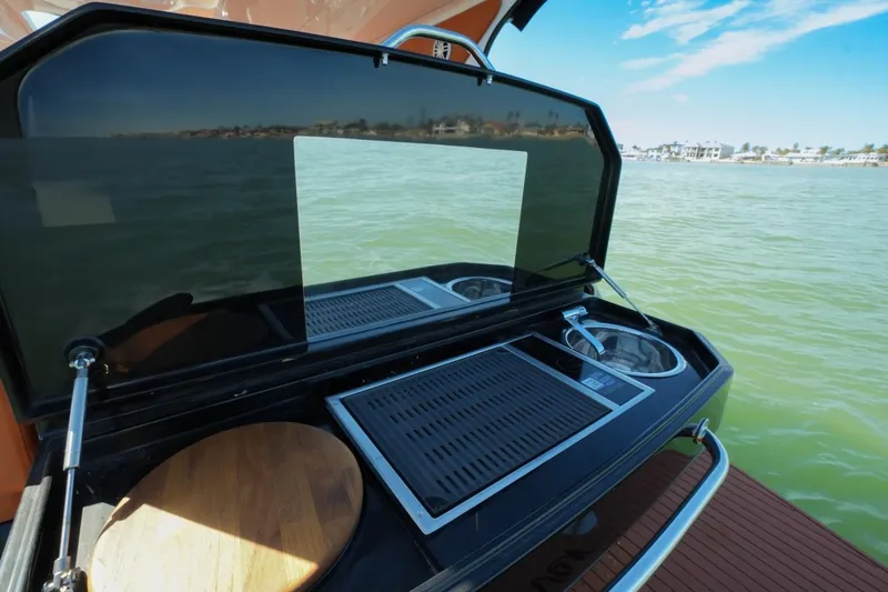 Slide: The Image of Outdoor kitchen on 2025 Hanover 355 Outboard boat with scenic water view. - 12