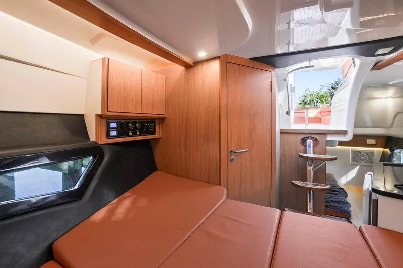 Slide: The Image of Interior of 2025 Hanover 355 Outboard boat with modern wood finish and cozy seating. - 13