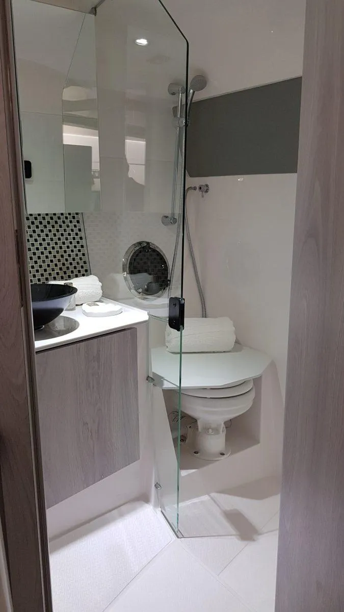 Slide: The Image of Modern bathroom in 2025 Hanover 355 Outboard boat with glass shower and sleek fixtures. - 17