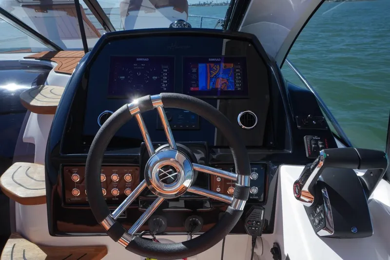 Slide: The Image of Steering console of 2025 Hanover 355 Outboard boat with navigation display and controls. - 7