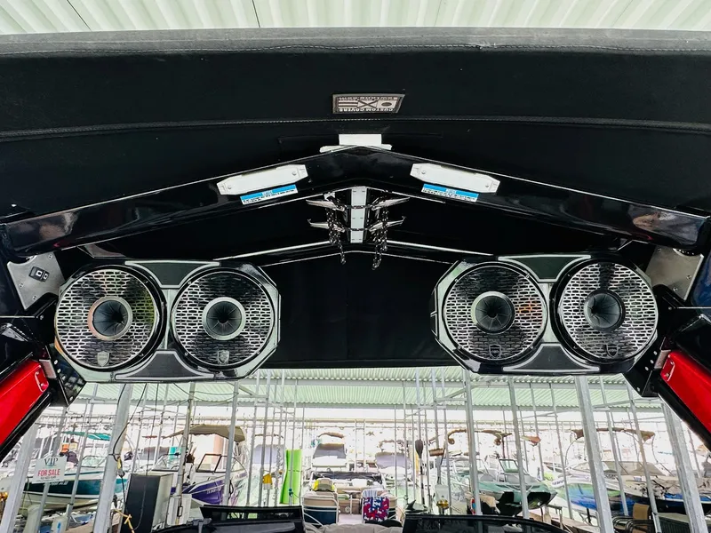 Slide: The Image of 2021 Centurion Ri265 boat speakers under canopy at marina. - 21