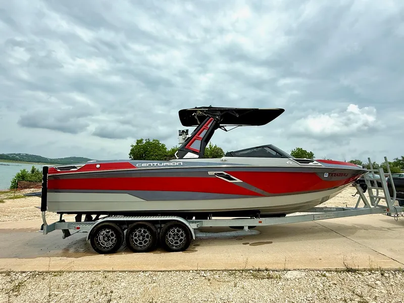 Slide: The Image of 2021 Centurion Ri265 boat on trailer by a lake under cloudy sky. - 5