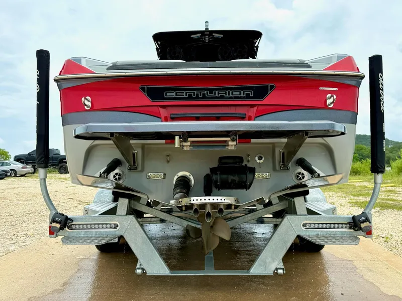 Slide: The Image of 2021 Centurion Ri265 boat on trailer, rear view, red and gray design. - 8