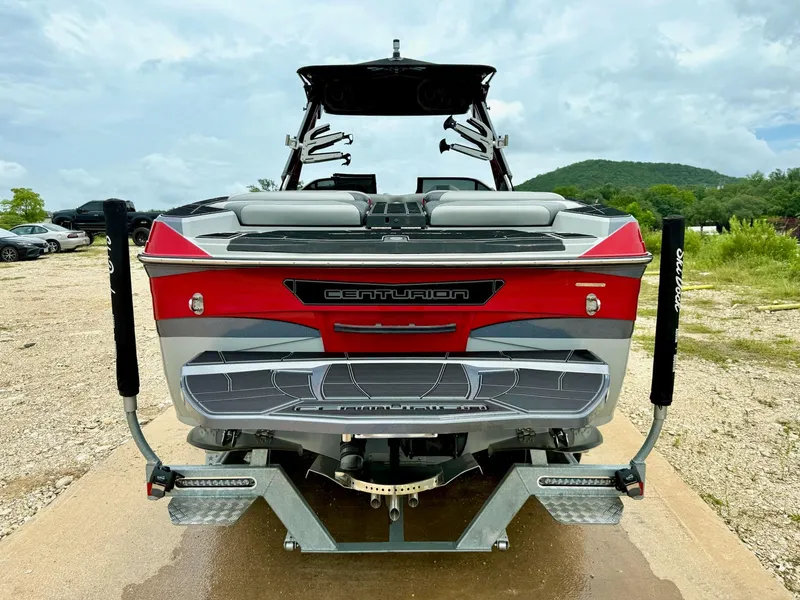 Slide: The Image of 2021 Centurion Ri265 boat on trailer, rear view, outdoors with cloudy sky. - 9