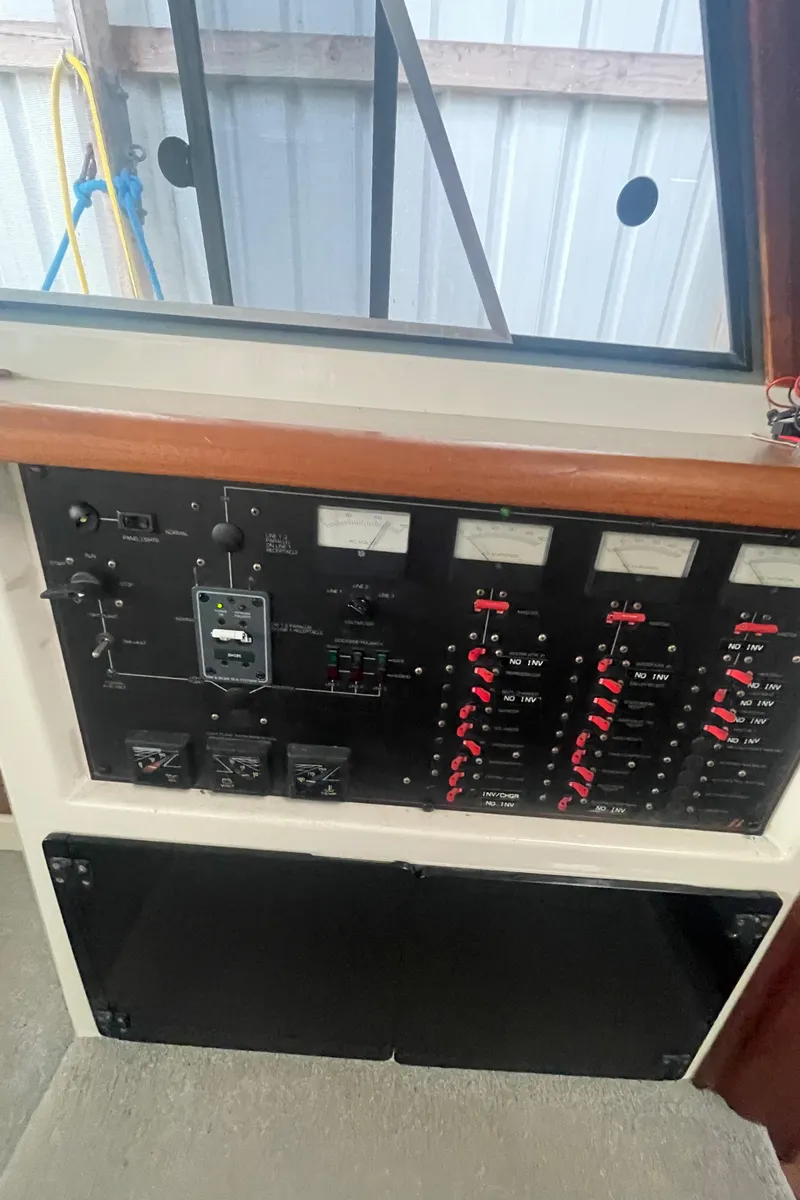 Slide: The Image of Electrical control panel of a 1988 Bayliner 4588 yacht, featuring gauges and switches. - 13