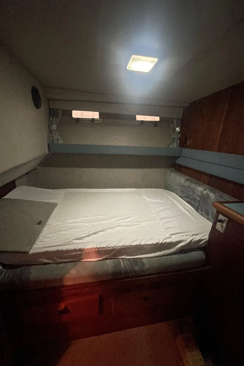Slide: The Image of Cozy cabin interior of 1988 Bayliner 4588 yacht with bed and soft lighting. - 17