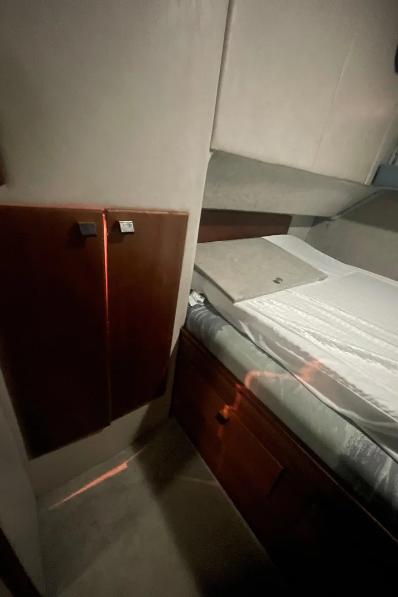 Slide: The Image of Interior cabin of 1988 Bayliner 4588 yacht with bed and wooden cabinets. - 18