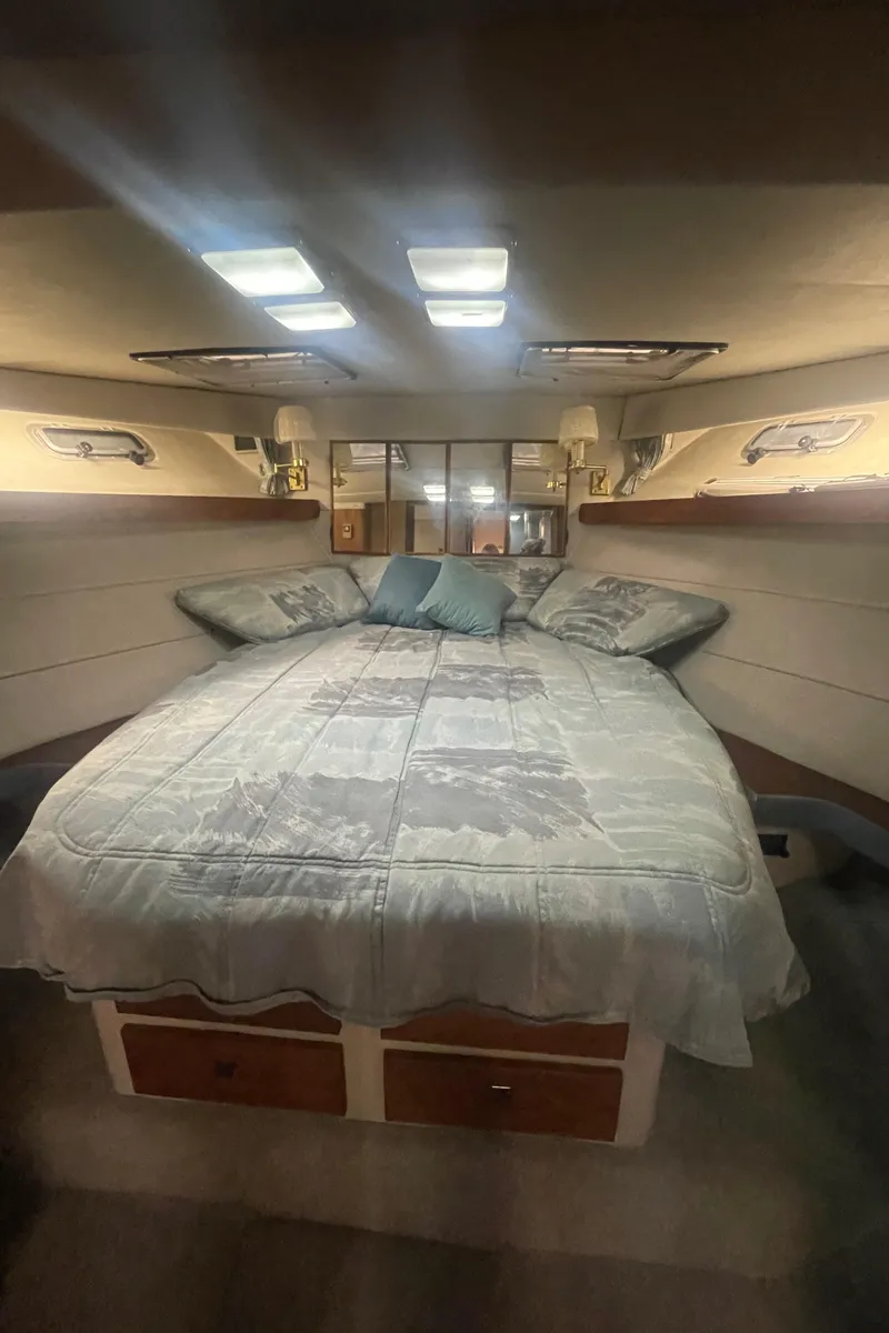 Slide: The Image of Interior cabin of 1988 Bayliner 4588 yacht with cozy bed and soft lighting. - 21