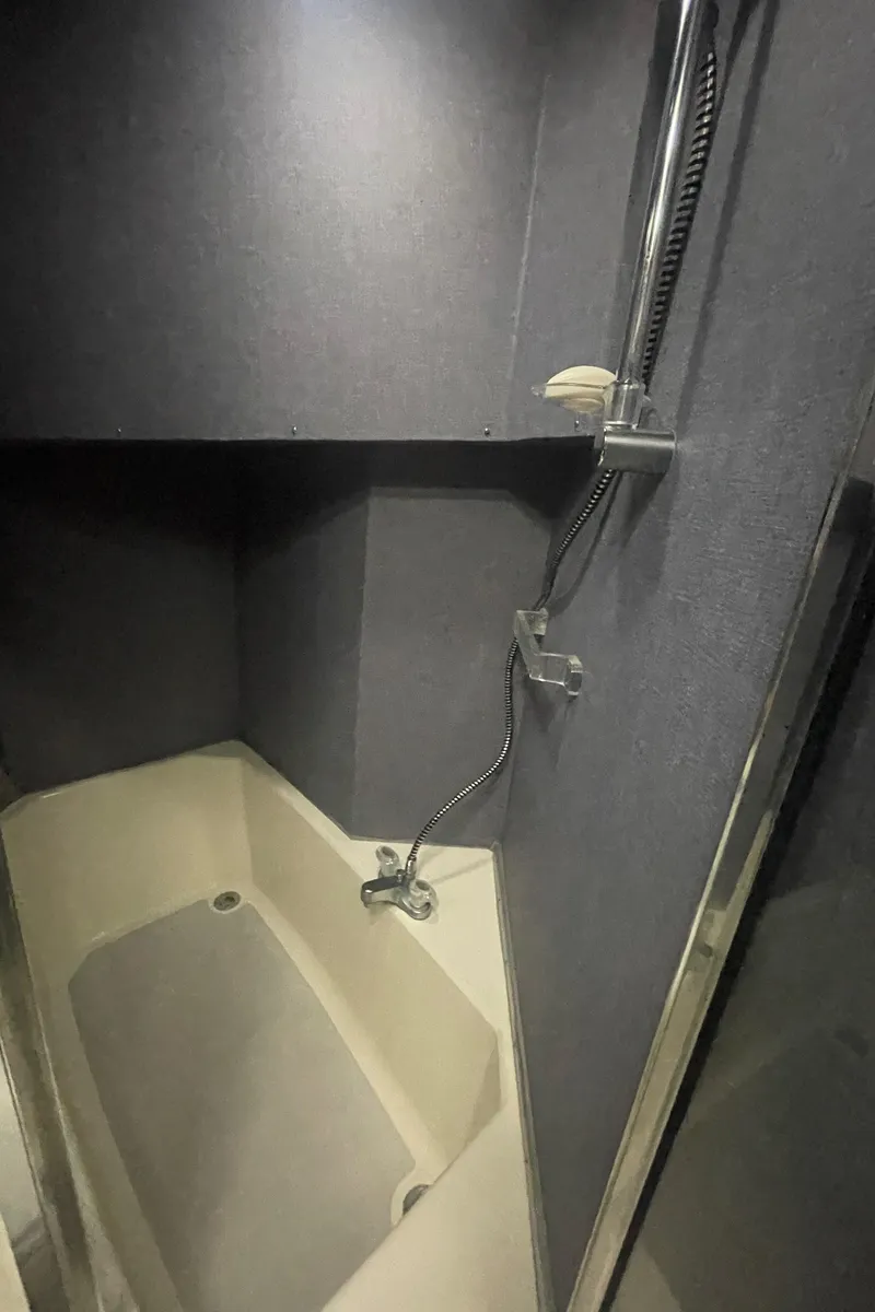 Slide: The Image of 1988 Bayliner 4588 yacht bathroom with shower and tub, featuring modern fixtures. - 22
