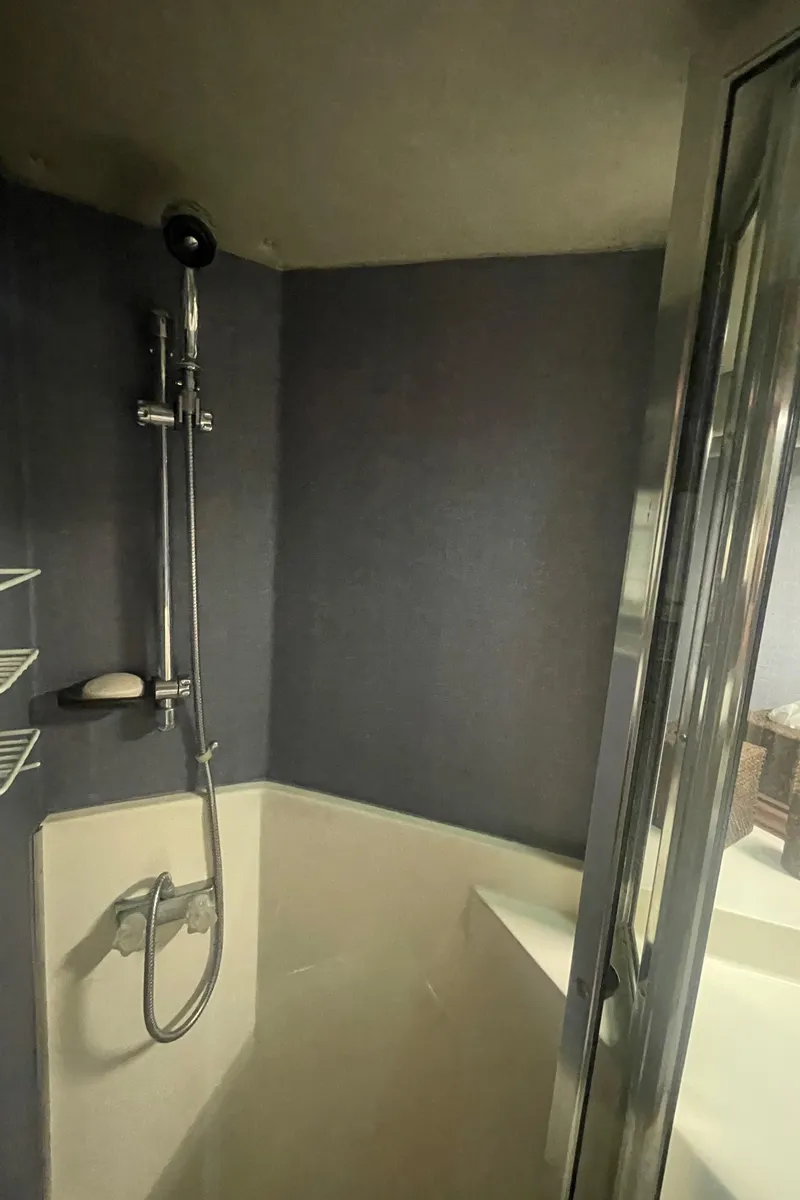 Slide: The Image of Shower area in 1988 Bayliner 4588 yacht with modern fixtures and glass door. - 23