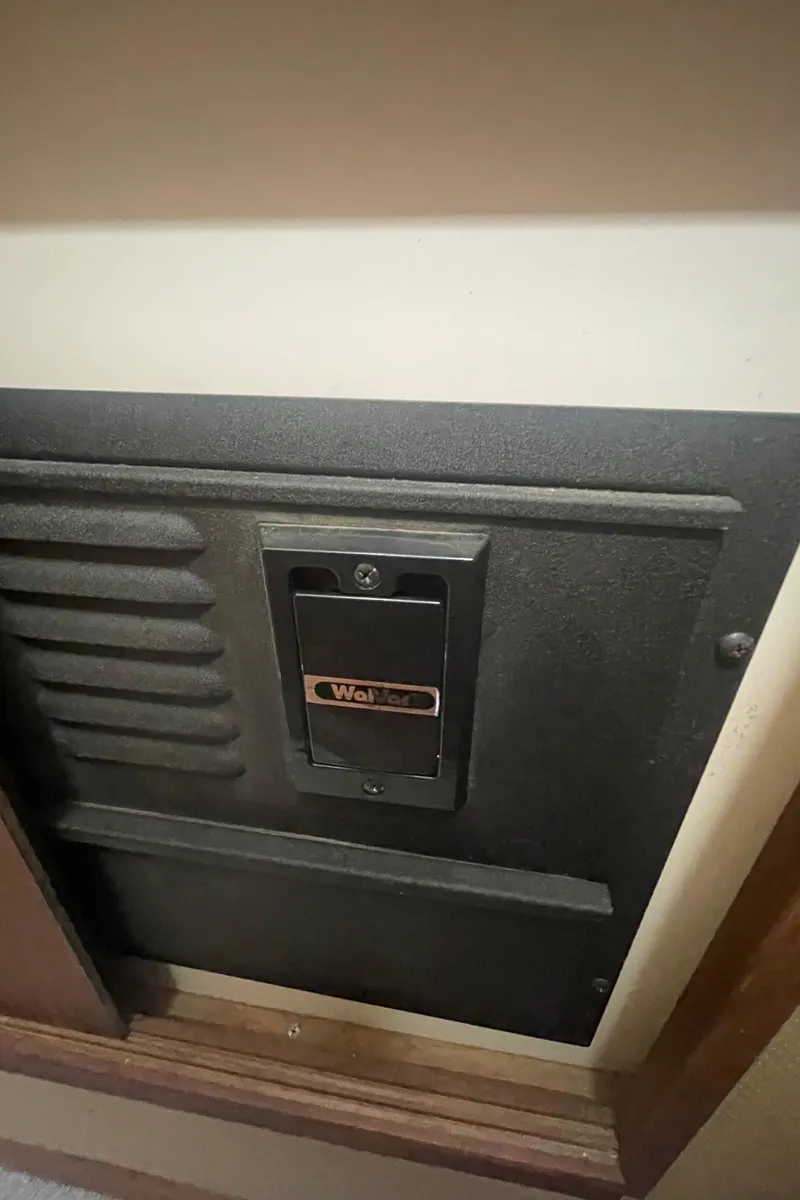 Slide: The Image of Wall-mounted panel inside 1988 Bayliner 4588 yacht, featuring a black vent and control switch. - 26