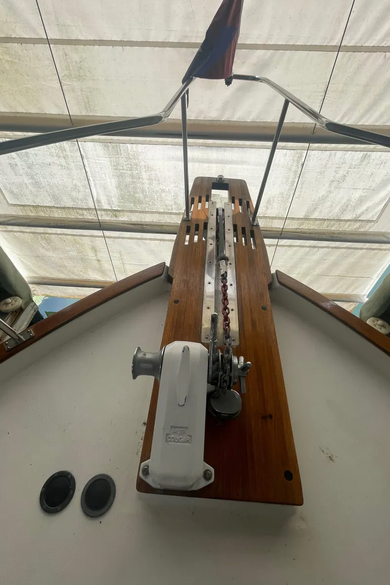 Slide: The Image of 1988 Bayliner 4588 yacht deck with anchor winch and wooden details. - 28