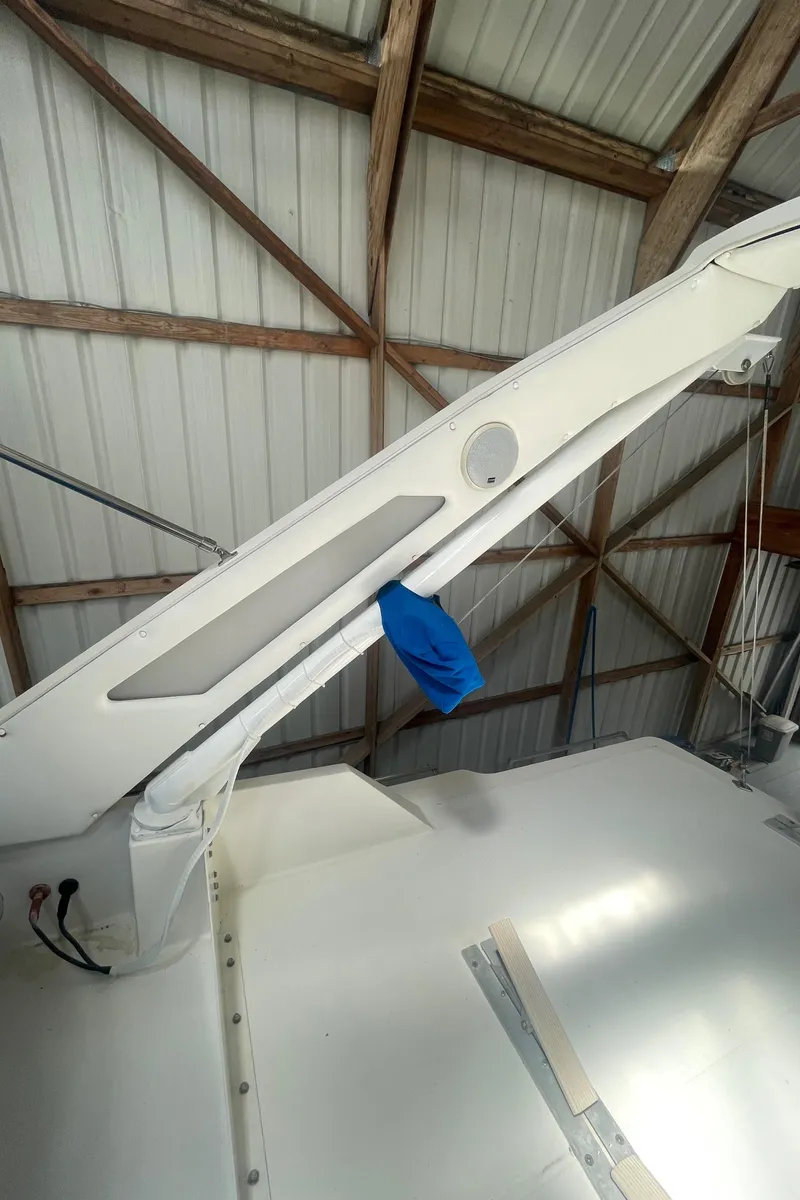 Slide: The Image of 1988 Bayliner 4588 yacht detail in a boathouse, showcasing structural elements and a blue cover. - 29