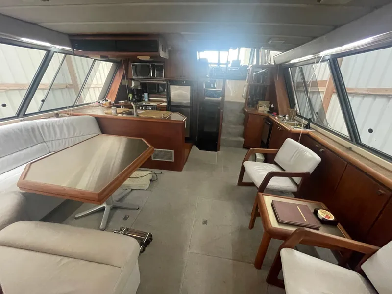 Slide: The Image of Interior of 1988 Bayliner 4588 yacht with dining area, kitchen, and seating. - 3