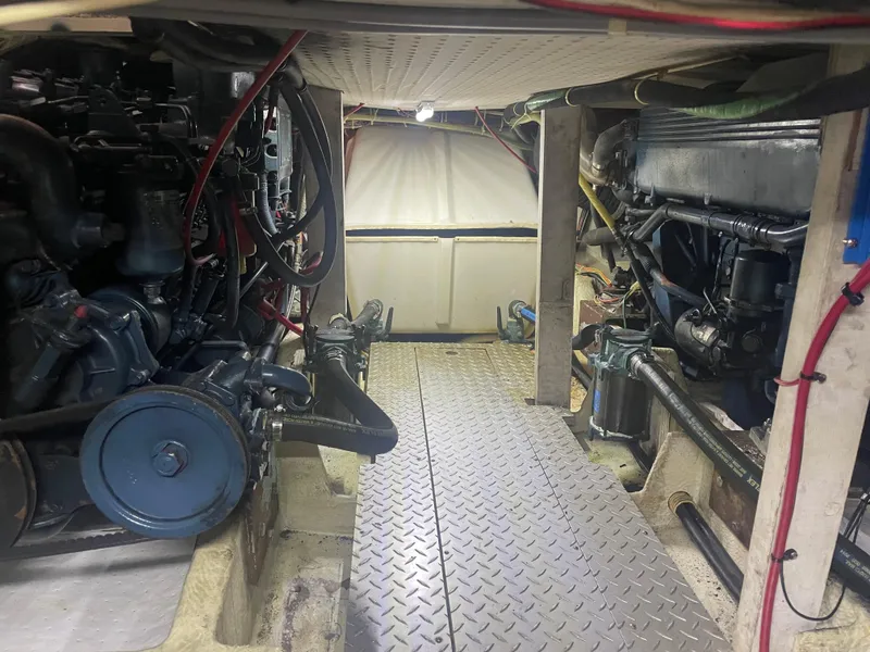 Slide: The Image of Engine room of a 1988 Bayliner 4588 yacht, showcasing mechanical components and wiring. - 33