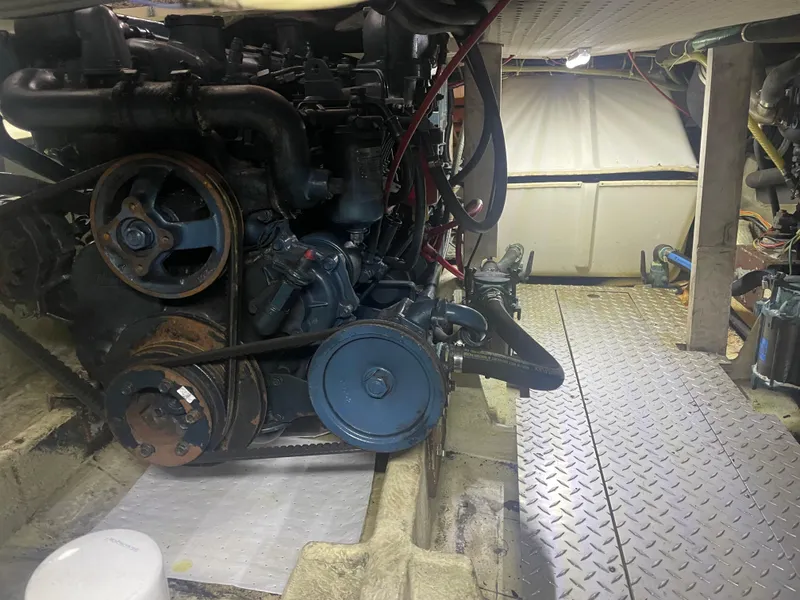 Slide: The Image of Engine room of a 1988 Bayliner 4588 yacht, featuring mechanical components and metal flooring. - 34