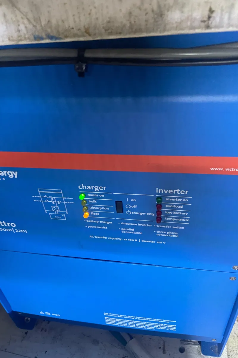 Slide: The Image of Blue Victron Energy charger and inverter panel on a 1988 Bayliner 4588 boat. - 37