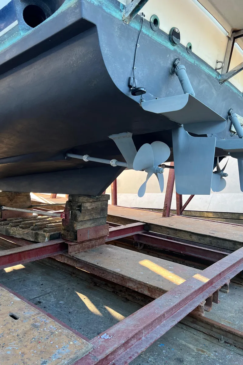 Slide: The Image of 1988 Bayliner 4588 yacht hull and propellers on dry dock for maintenance. - 43