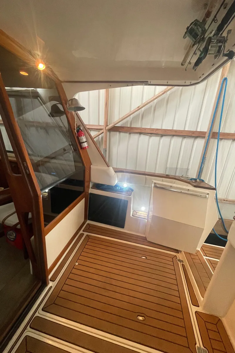 Slide: The Image of 1988 Bayliner 4588 yacht interior with wood flooring and modern amenities. - 5