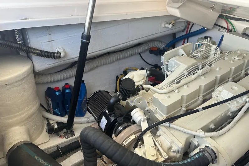 Slide: The Image of Engine compartment of a 2005 Tiara Yachts 3800 Open, showcasing mechanical components and oil containers. - 16