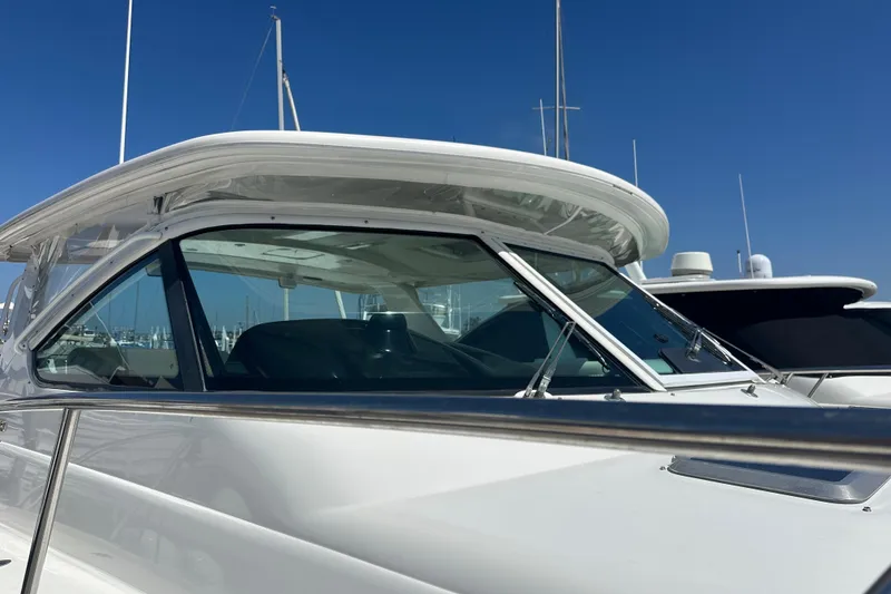 Slide: The Image of 2005 Tiara Yachts 3800 Open, sleek design, docked under clear blue sky. - 2