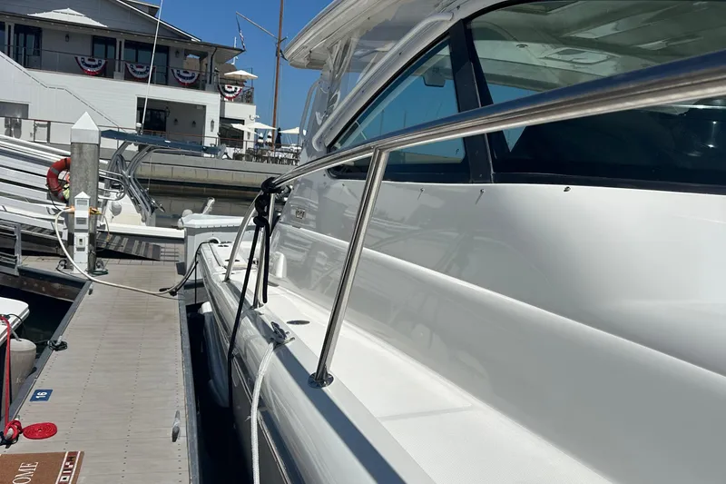 Slide: The Image of 2005 Tiara Yachts 3800 Open docked at marina, showcasing sleek design and polished exterior. - 3