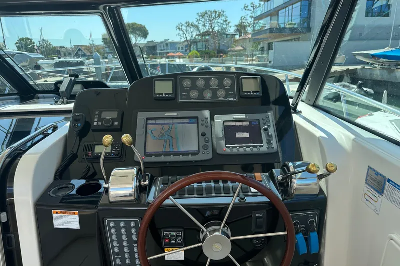 Slide: The Image of Helm of 2005 Tiara Yachts 3800 Open with navigation equipment and steering wheel. - 6