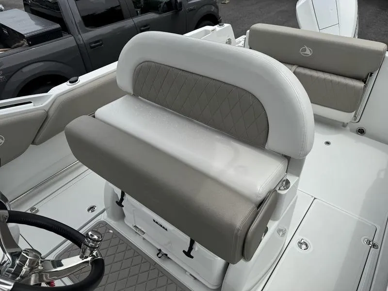 Slide: The Image of 2024 Finseeker 230 CC boat interior with cushioned seating and steering wheel. - 10