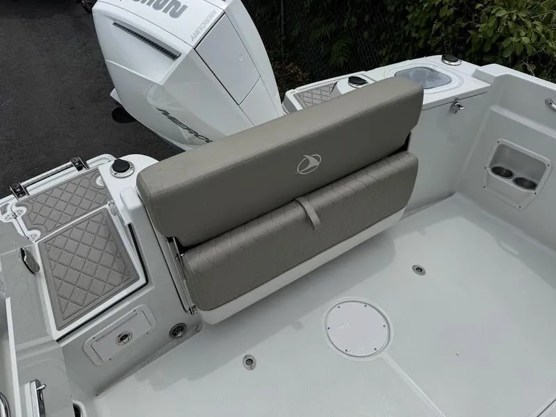 Slide: The Image of 2024 Finseeker 230 CC boat interior with cushioned seating and outboard motor. - 4
