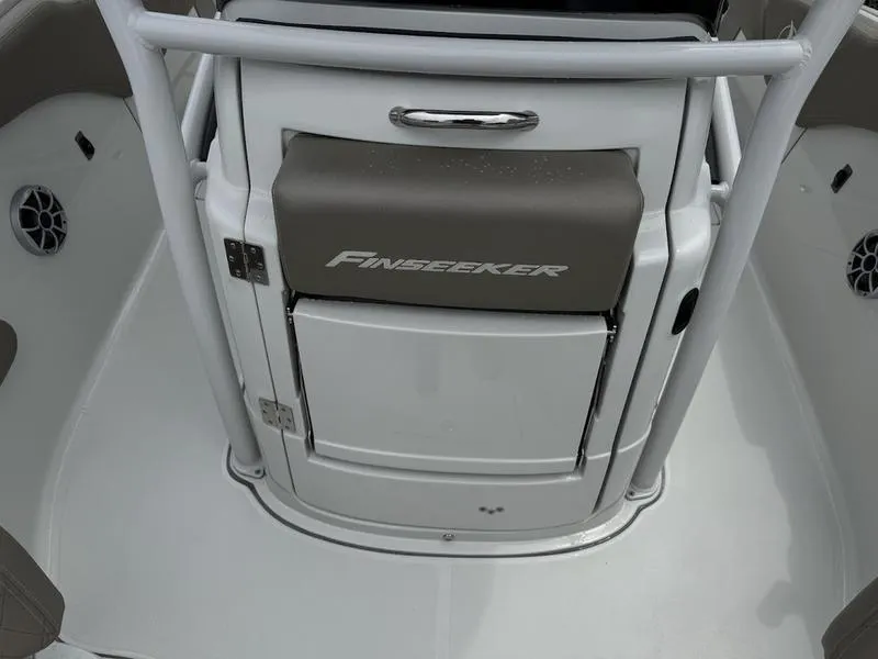 Slide: The Image of 2024 Finseeker 230 CC boat interior with storage compartment and seating. - 5
