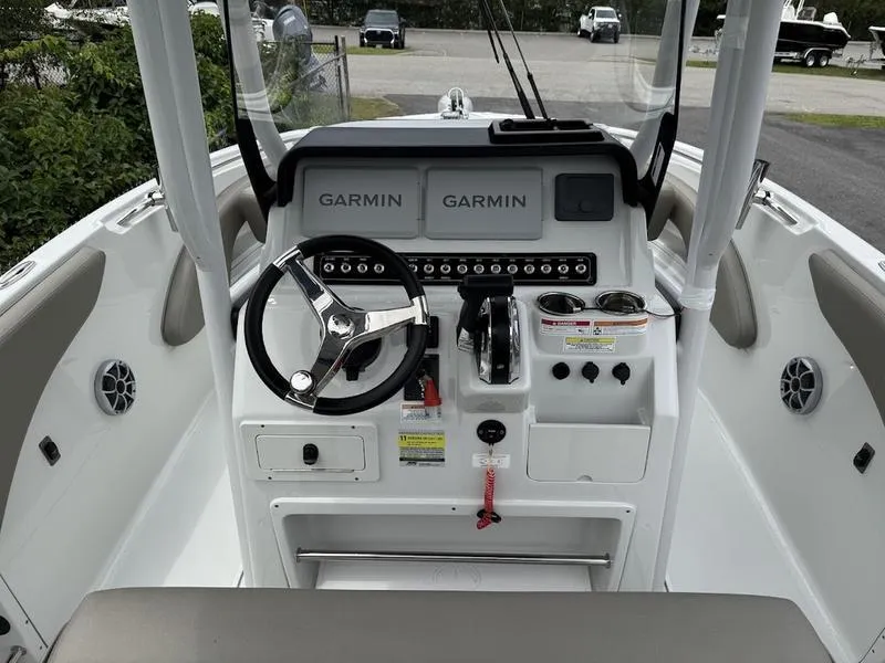 Slide: The Image of 2024 Finseeker 230 CC boat dashboard with Garmin navigation systems and steering wheel. - 6