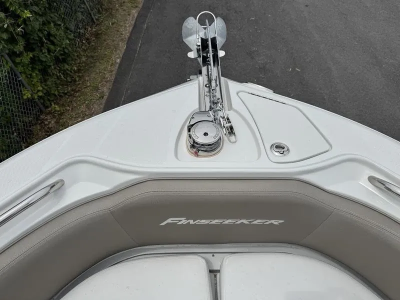 Slide: The Image of 2024 Finseeker 230 CC boat bow with anchor and seating area. - 8