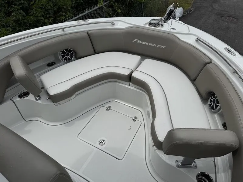 Slide: The Image of 2024 Finseeker 230 CC boat interior with cushioned seating and storage compartment. - 9