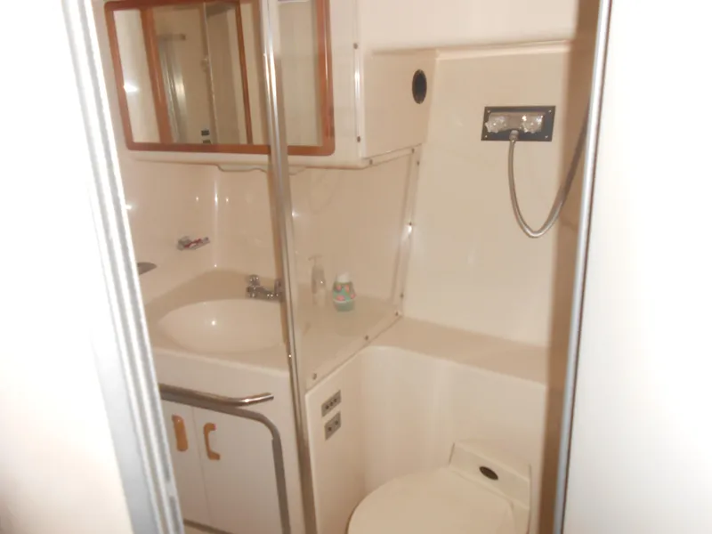 Slide: The Image of Bathroom interior of 1990 Sea Ray 350 Sundancer Coupe yacht, featuring sink and shower. - 10