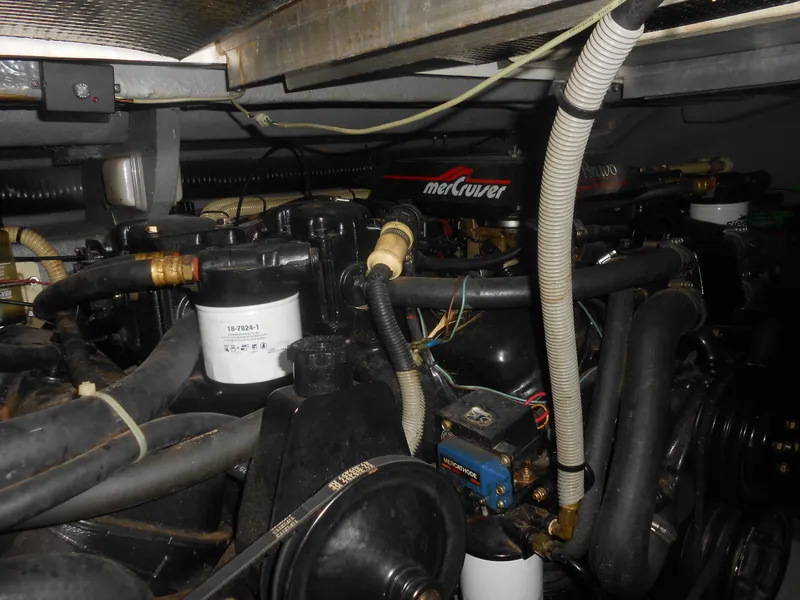 Slide: The Image of Engine compartment of a 1990 Sea Ray 350 Sundancer Coupe with MerCruiser components. - 15