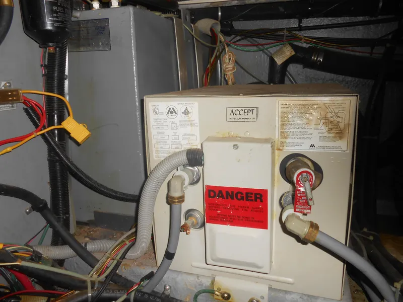 Slide: The Image of Engine room of 1990 Sea Ray 350 Sundancer Coupe with wiring and warning labels. - 18