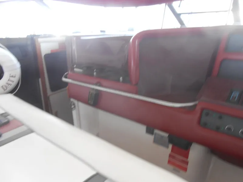 Slide: The Image of Interior of 1990 Sea Ray 350 Sundancer Coupe with white and striped seating. - 3