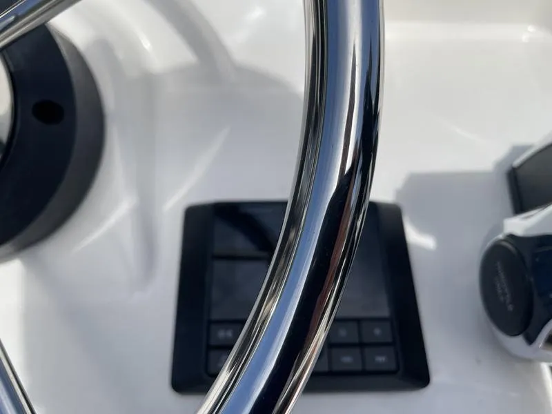 Slide: The Image of Close-up of 2024 Boston Whaler 150 Montauk steering wheel and dashboard controls. - 7