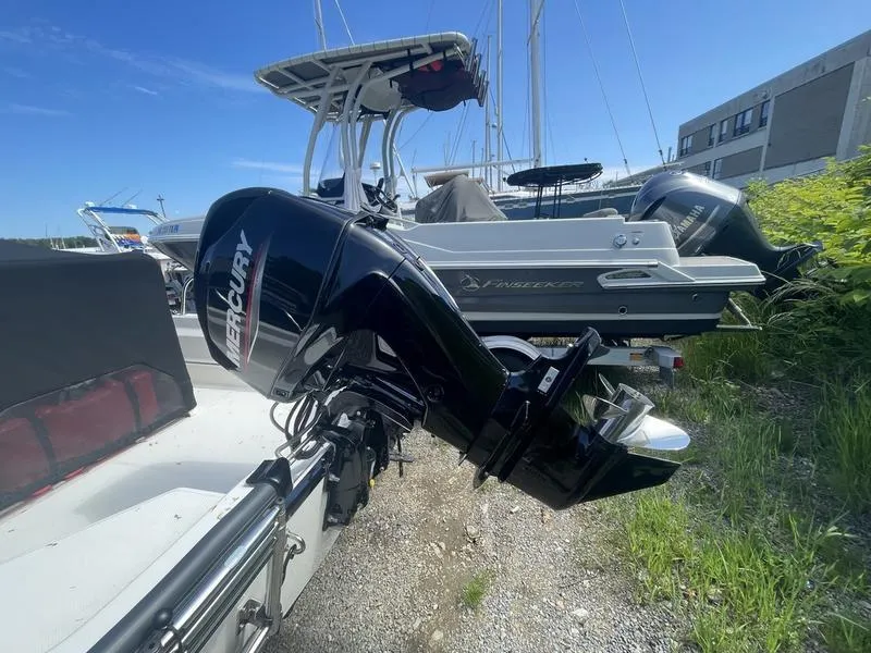 Slide: The Image of 2024 Boston Whaler 150 Montauk with Mercury outboard motor, docked outdoors. - 8