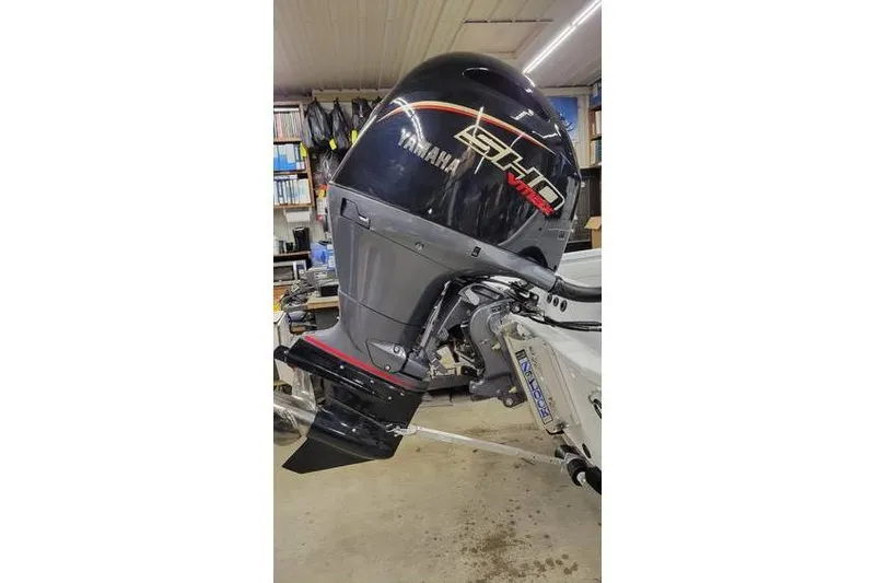 Slide: The Image of 2025 Xpress H20C Crappie boat with Yamaha outboard motor in a garage setting. - 21