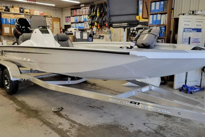 Slide: The Image of 2025 Xpress H20C Crappie boat on trailer in a workshop setting. - 23