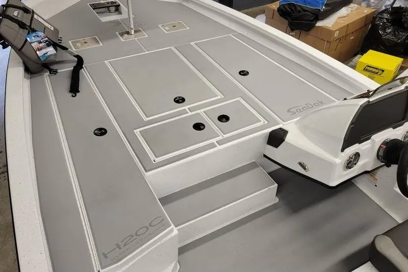Slide: The Image of 2025 Xpress H20C Crappie boat interior with SeaDek flooring and storage compartments. - 25