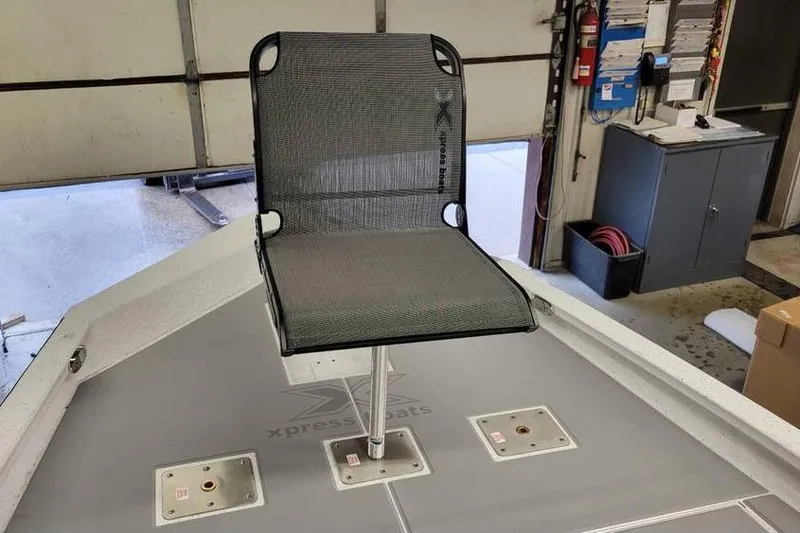 Slide: The Image of 2025 Xpress H20C Crappie boat seat in a garage setting. - 28