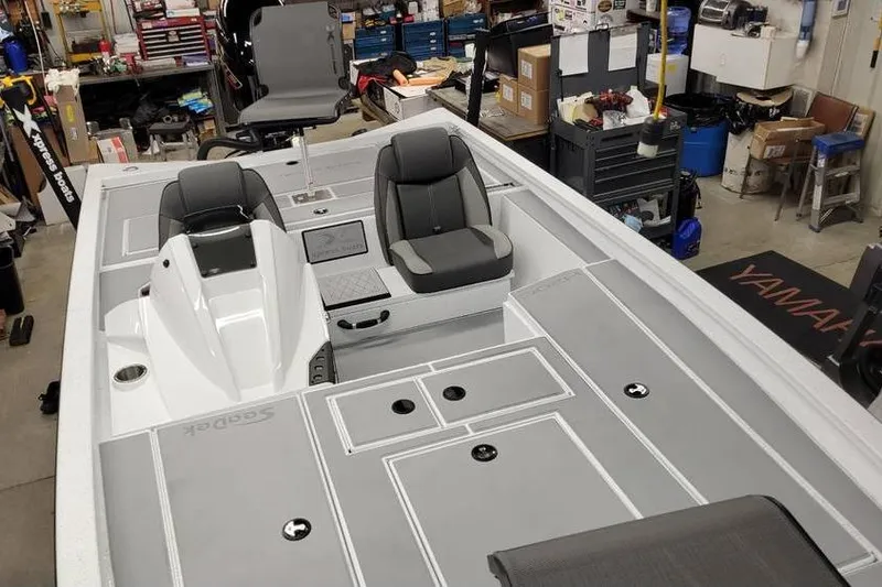 Slide: The Image of 2025 Xpress H20C Crappie boat interior with gray seating and storage compartments. - 29