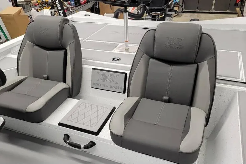 Slide: The Image of 2025 Xpress H20C Crappie boat interior with two gray seats and logo detailing. - 30