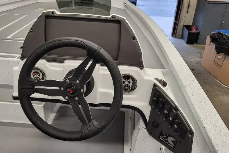 Slide: The Image of 2025 Xpress H20C Crappie boat dashboard with steering wheel and control panel. - 34