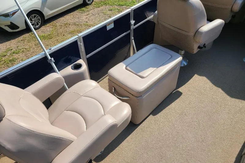 Slide: The Image of 2013 Starcraft Limited 236 Starlounger interior with beige seating and storage compartment. - 2