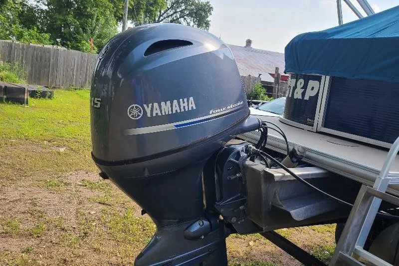 Slide: The Image of Yamaha outboard motor on 2013 Starcraft Limited 236 Starlounger boat, parked outdoors. - 6
