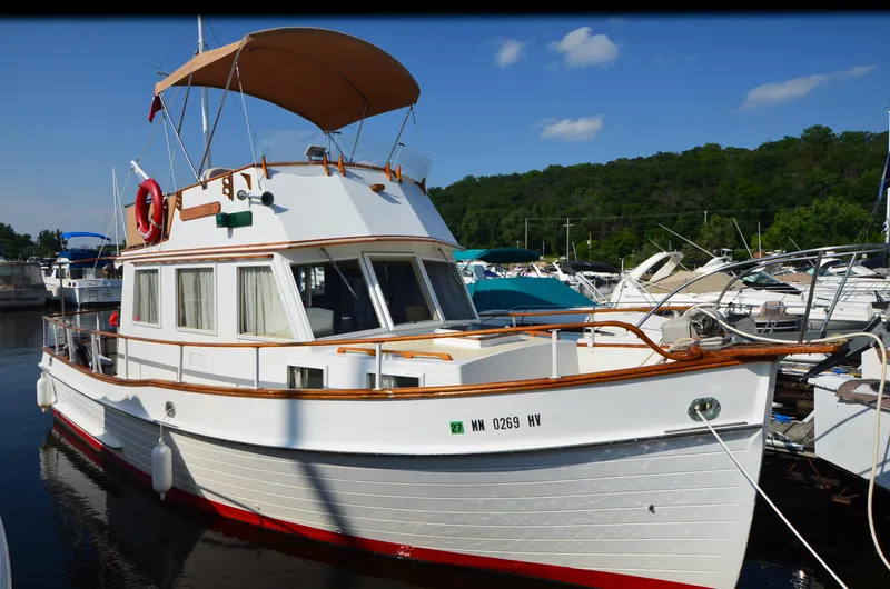 The Image of 1977 Grand Banks GB 32 boat docked at marina, featuring classic design and wooden accents. - 1