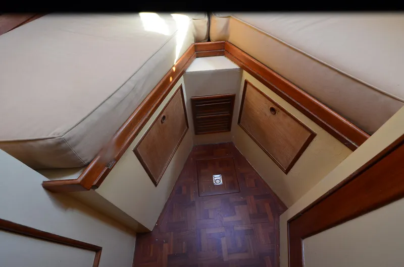 Slide: The Image of Interior cabin of 1977 Grand Banks GB 32 with wood paneling and cushioned seating. - 11